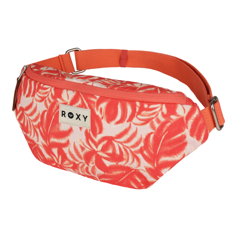 The Vanilla Smoothie Crossbody Bag by Roxy features a coral and white leaf pattern, an orange adjustable strap, zipper closure, and a rectangular ROXY logo patch on the front, offering a stylish hands-free carrying option.