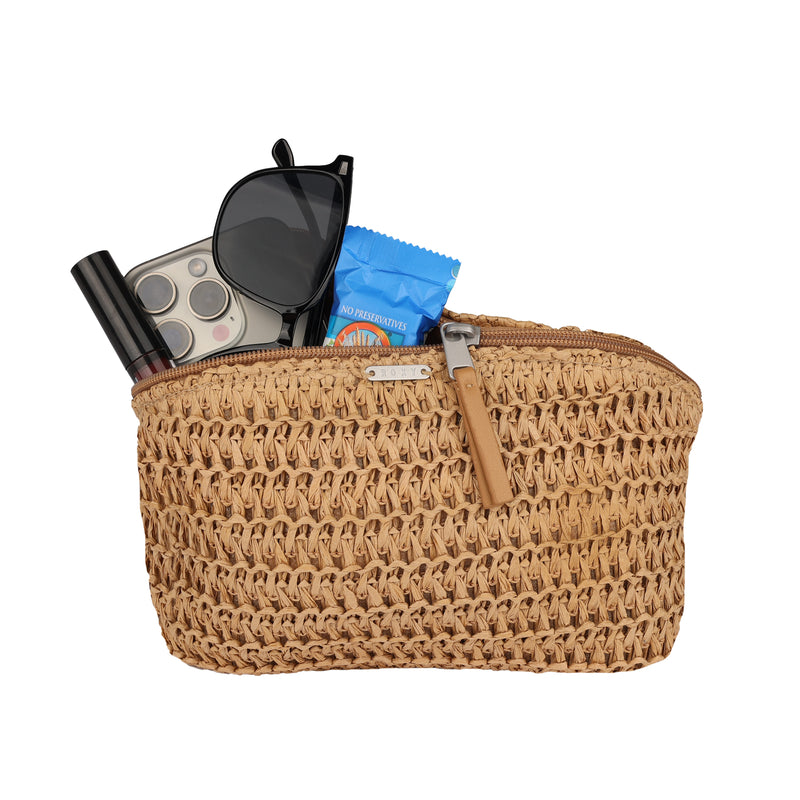 The Roxy Spotless Sunnies Fanny Pack is a woven beige waist pack with a zipper, ideal for hands-free use. It's shown holding a smartphone, black sunglasses, lipstick, and a blue-packaged item partially visible.