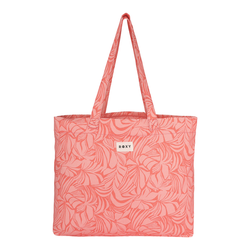 The ROXY Sweeter Than Honey Tote Bag features double handles, a white ROXY label, and an all-over abstract leaf pattern. This eco-friendly tote is made from soft recycled cotton in a simple rectangular shape with a fabric texture.