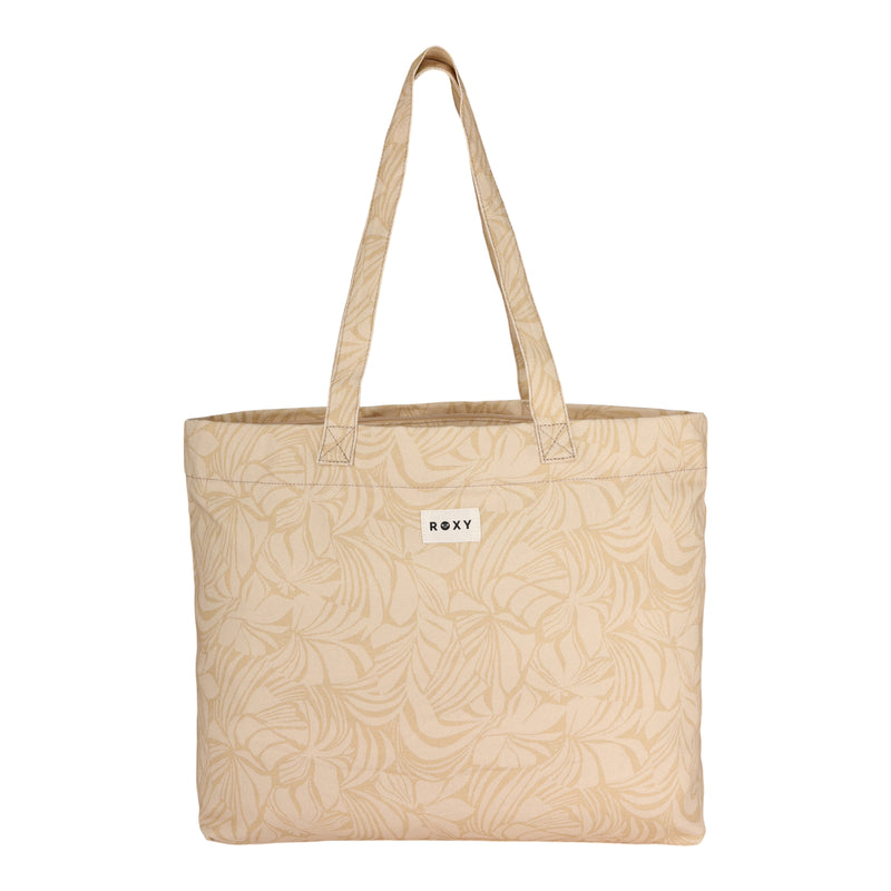 The ROXY Sweeter Than Honey Tote Bag is a beige, eco-friendly tote featuring subtle leaf patterns, two handles, and a small white ROXY logo tag on the front. Made from recycled cotton, it is shown empty against a white backdrop.