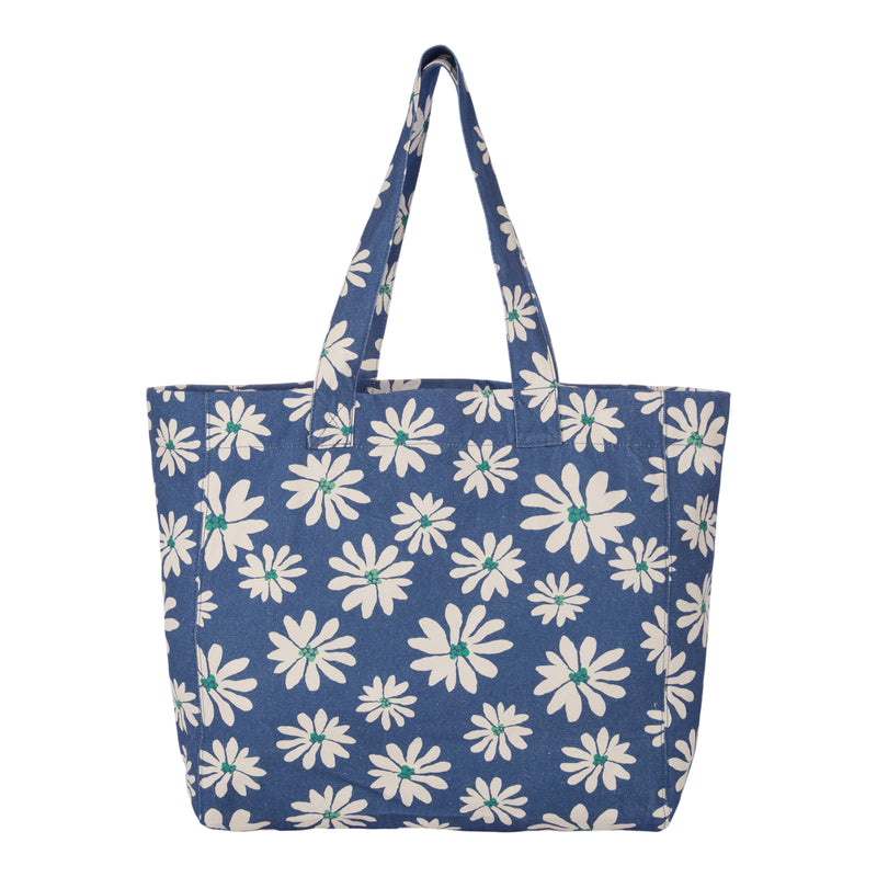 The Roxy Anti Bad Vibes Tote Bag is a stylish accessory made from recycled cotton and features long handles for easy carrying. Its blue canvas is adorned with a repeating pattern of white daisy-like flowers with small green centers, creating a vibrant look that stands out against a white background. Perfect for any occasion, this beautiful tote showcases both sustainability and style.