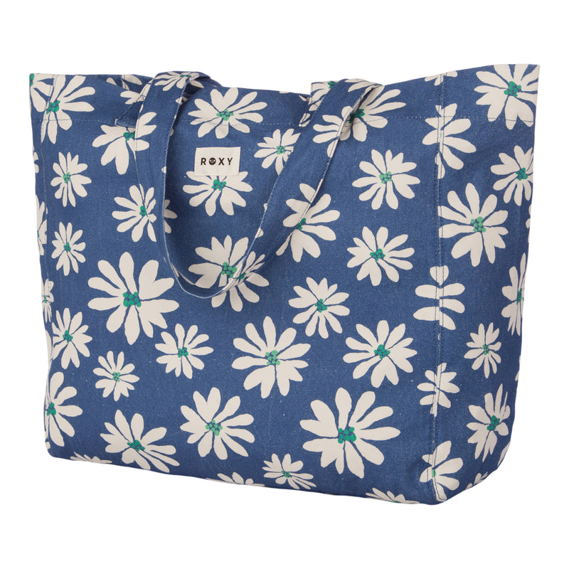 The Anti Bad Vibes Tote Bag by Roxy is a blue canvas tote bag featuring a playful white daisy print with green centers. Designed with two sturdy handles and a discreet ROXY label on one side, it’s the perfect accessory for any outing.