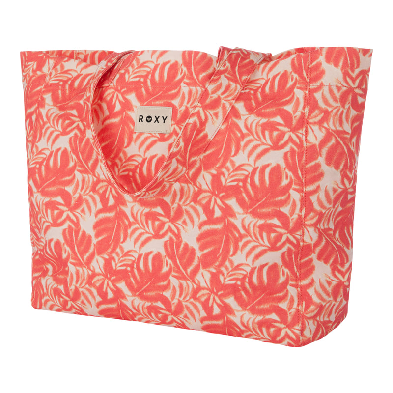 The Roxy Anti Bad Vibes Tote Bag is a stylish tote with handles, showcasing a pink and white tropical leaf pattern and a small Roxy label on the front. Made from recycled cotton, this bag offers both eco-friendly appeal and fashionable design.