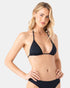 A woman with long blonde hair models the Roxy Sd Beach Classics Tiki Tri black triangle bikini top, made from recycled nylon. She poses against a plain light background, accessorizing with gold hoop earrings, layered necklaces, and a bracelet.