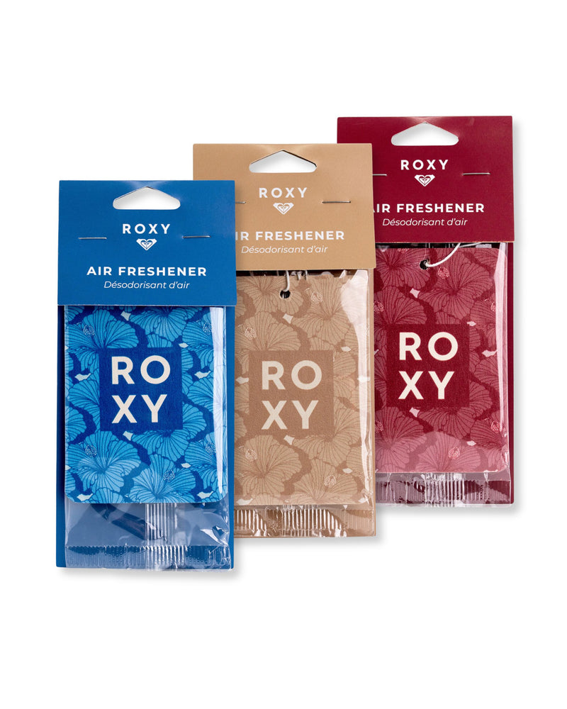 Three ROXY Air Freshener 3-Pack Holiday Variety Pack hanging air fresheners in Vanilla Solstice blue, Apres Shimmer tan, and red, each with a floral pattern and the brand name printed on the packaging.