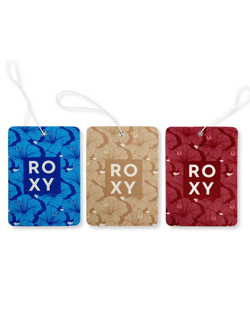 Three rectangular ROXY Air Freshener 3-Pack Holiday Variety Pack hanging air fresheners in blue Frost Rush, tan Vanilla Solstice, and red, each with a floral pattern and a central square logo.