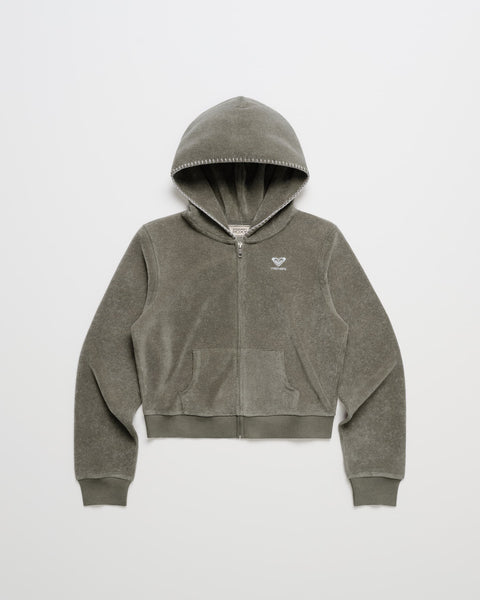 Clay ROXY x Madhappy Terry Shrunken Full Zip Jacket with front pockets, ribbed cuffs and hem, and a small white logo on the left chest, laid flat on a white background—perfect as a cozy beachy layer.