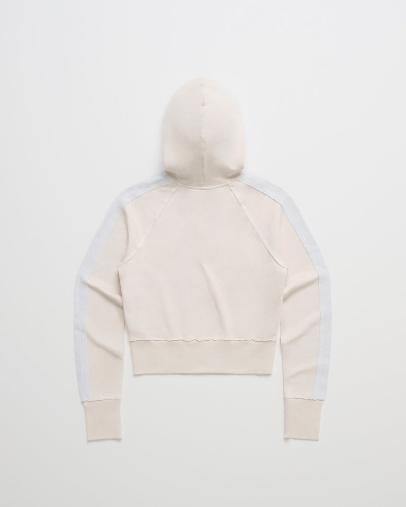 The ROXY x Madhappy French Terry Shrunken Full Zip Jacket is a light beige hooded sweatshirt, shown from the back, with long sleeves featuring white stripes down the arms. Crafted from soft French terry fabric, this full zip jacket appears plain with no visible logos or designs.