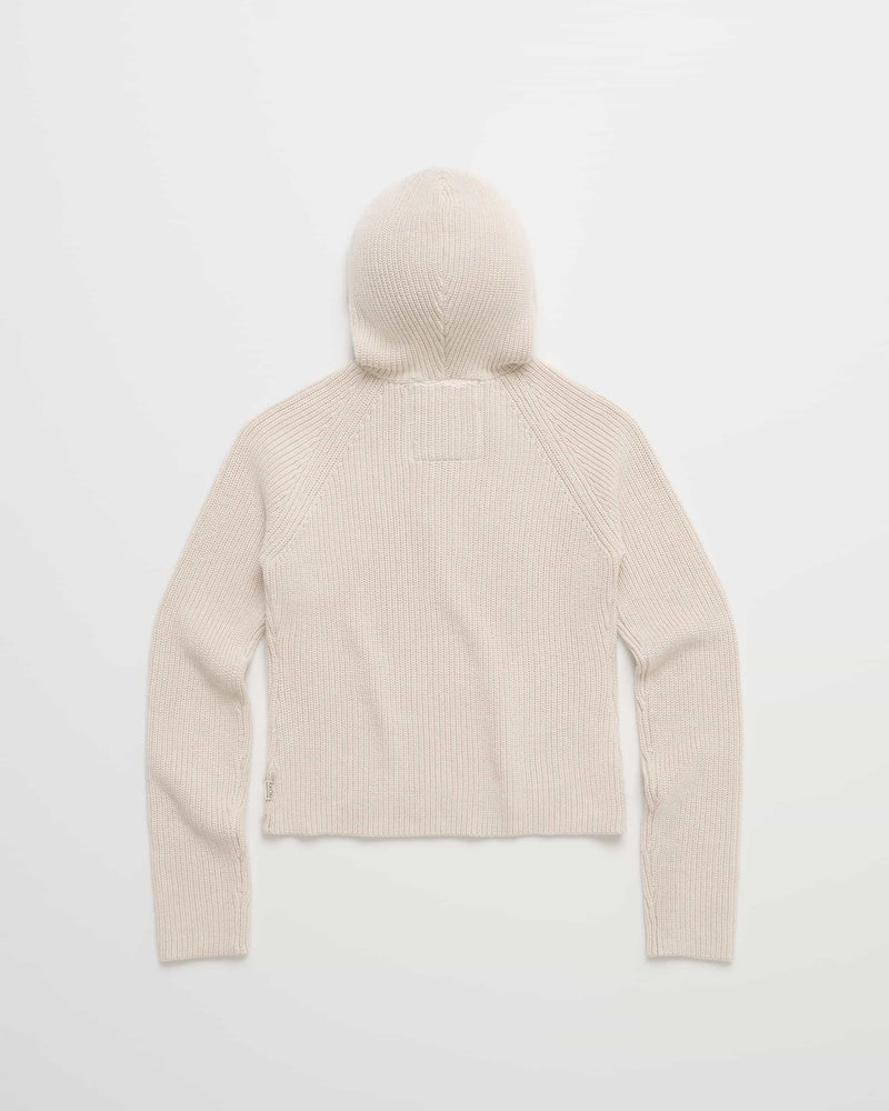 The Roxy x Madhappy Shrunken Rib Hoodie, a cream-colored, ribbed knit piece, is shown laid flat with the back facing up, highlighting its long sleeves and signature square patch on the upper back—a stylish rib hoodie ideal for casual layering.