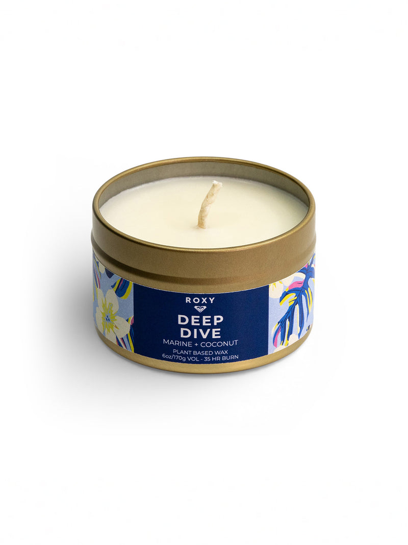 A round tin candle, the Roxy Deep Dive Palm Tin Candle, features a floral design. Its unused white wax offers a fresh marine breeze and creamy coconut scent, with an upright wick and up to 45 hours of burn time.