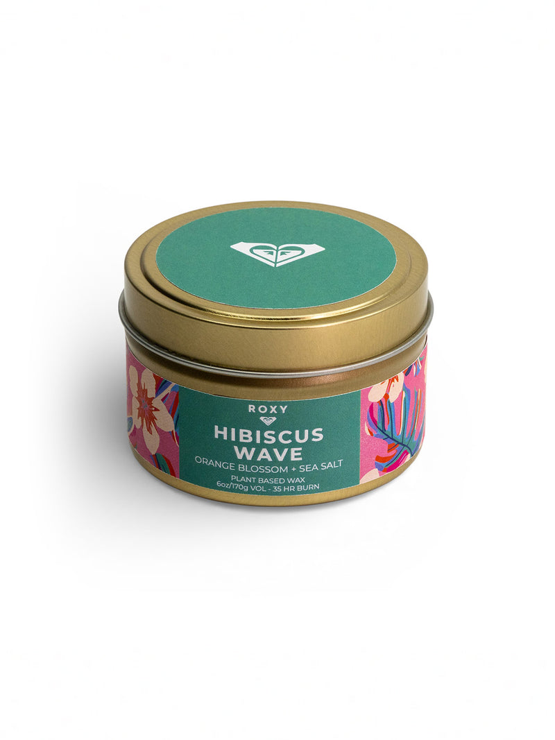 The Roxy Hibiscus Wave Palm Tin Candle in a small round tin with a gold lid and colorful floral label delivers a tropical scent of orange blossom and sea salt; hand-poured, 60g, with a 17-hour burn time.
