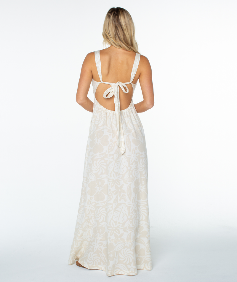 Back view of the cream-colored Roxy Wilder Coast Dress, featuring a sleeveless maxi silhouette with a hibiscus floral print and a tie back closure.