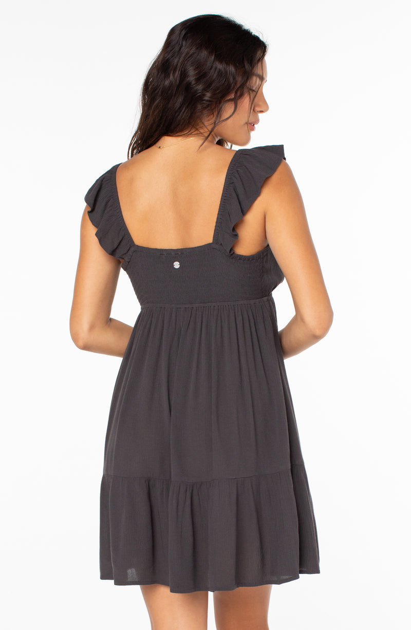 Back view of the Roxy Palmy Days Mini Dress, a charcoal gray mini dress with ruffled straps and a tiered skirt.