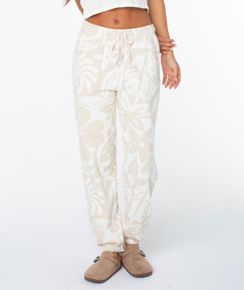 Roxy Maile Printed Pant high-waisted joggers in a cream and beige bold floral pattern, featuring an elastic drawstring waistband and cinched cuffs.