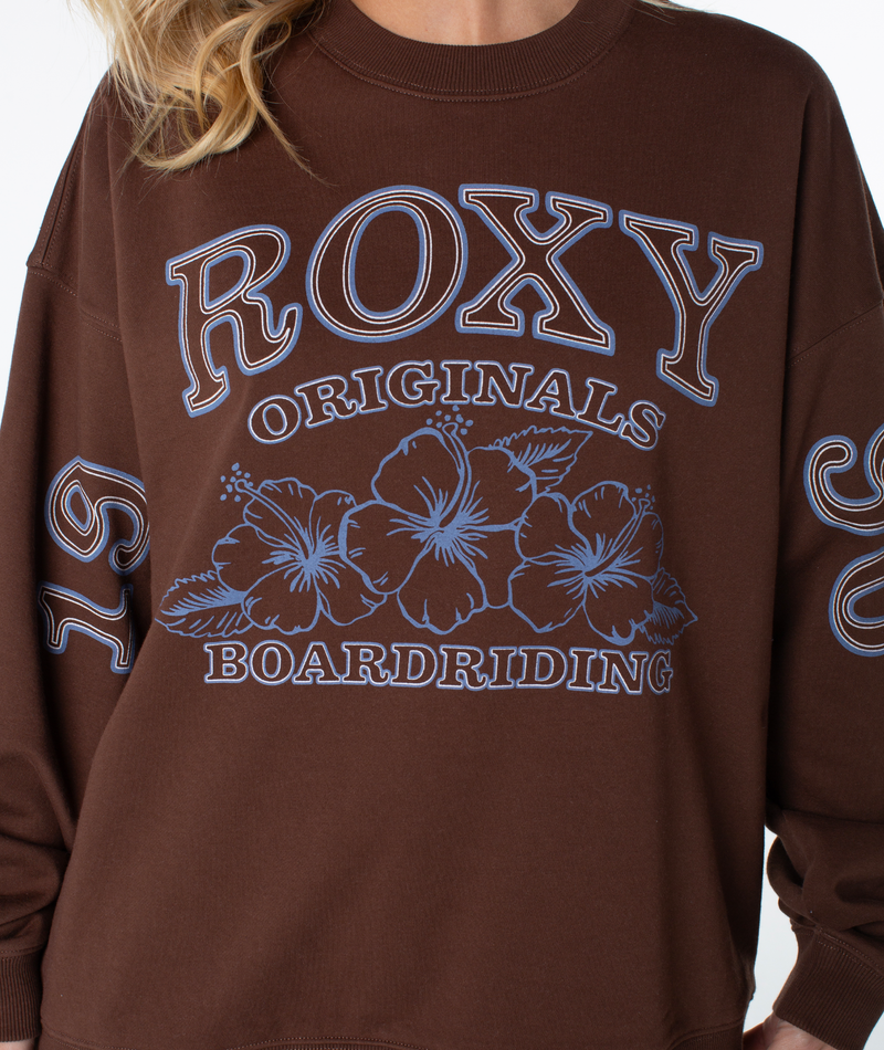 Brown Roxy Line Up Crew Top featuring blue graphic text and hibiscus flower illustrations.