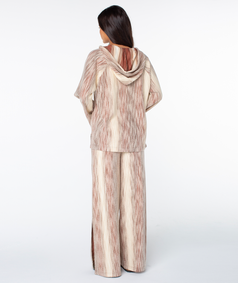 Back view of a person wearing the Roxy Wild And Free Top and matching wide-leg trousers, both in a textured, brown and cream striped terry fabric.