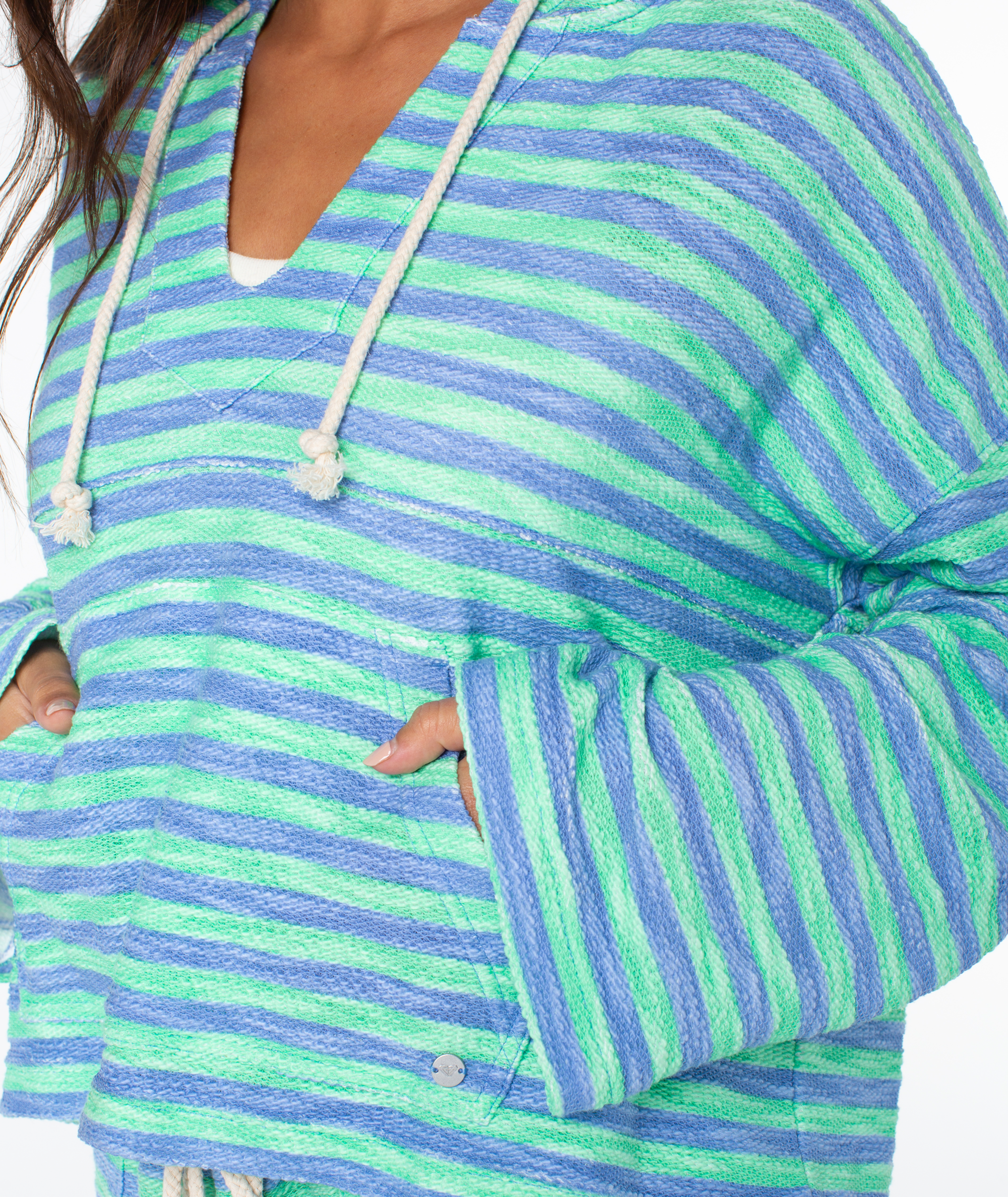 A person wearing the Roxy Rich Coast Stripe Hoodie in blue and green stripes with white drawstrings and front pockets, shown from shoulders to waist.