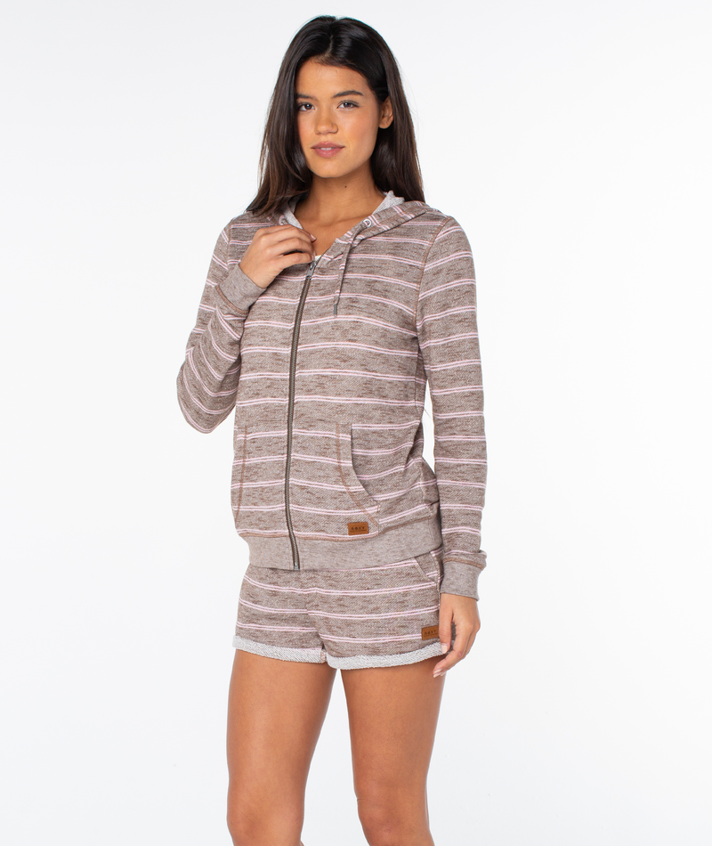 A model wears a cozy, brown and white striped Roxy Perfect Wave Stripe Top zip-up hoodie and matching shorts for a casual look.