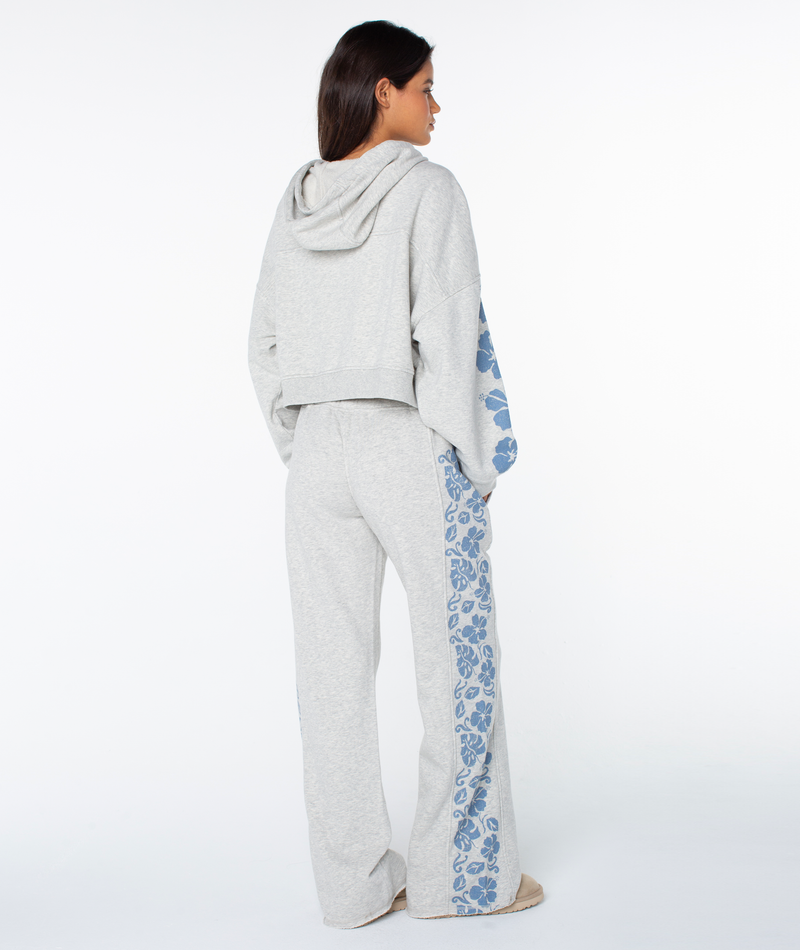 Woman wearing the Roxy Fringing Reefs Top in light gray with blue leopard print down the sleeves—stylish and cozy loungewear, shown from the back.