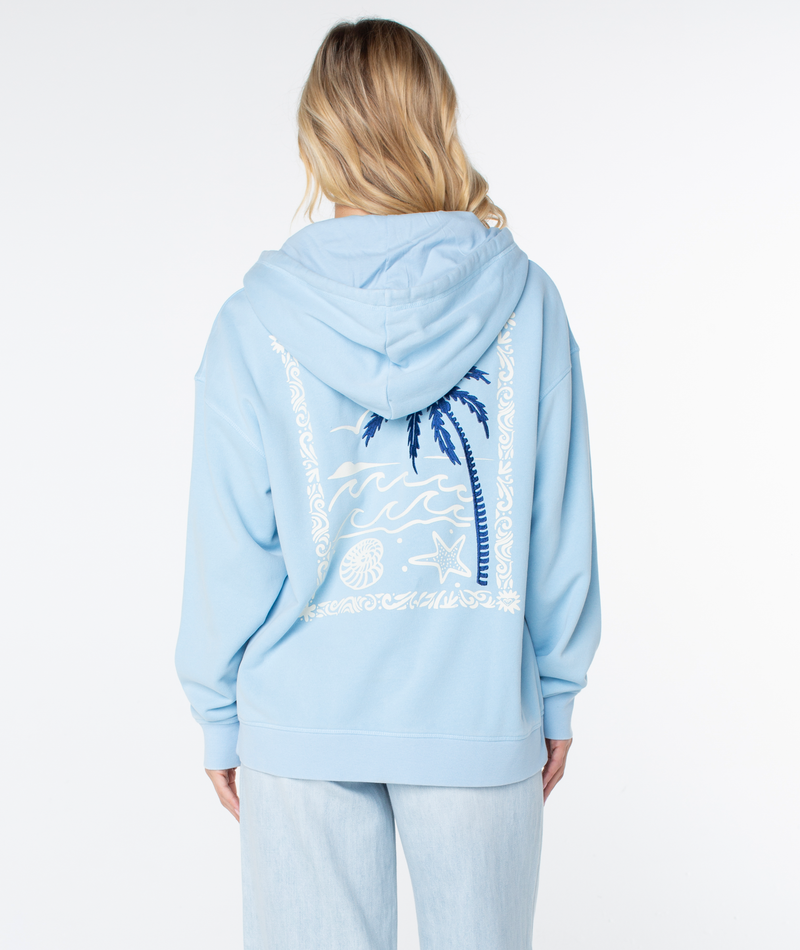 A person with long blonde hair, facing away, wears a light blue Roxy Wailea Hoodie featuring beach-themed designs—palm trees, waves, a shell, and starfish—on the back.