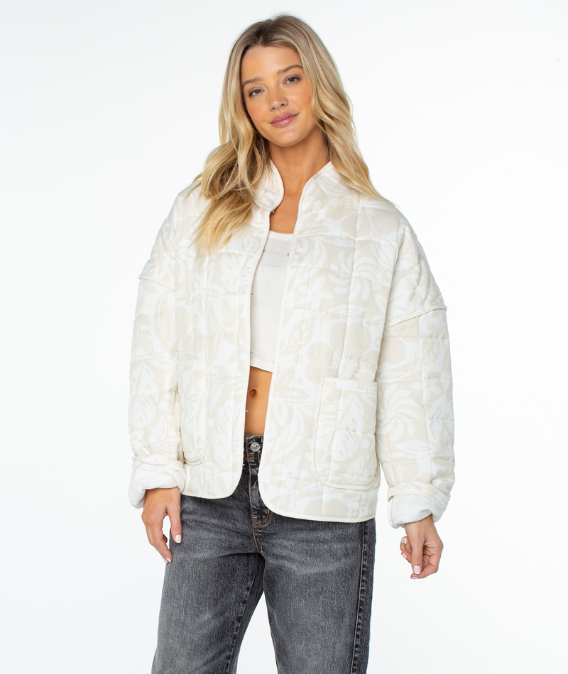 Roxy Solana Jacket in cream with a relaxed fit, featuring a subtle leaf pattern, high collar, drop shoulders, and two front patch pockets.
