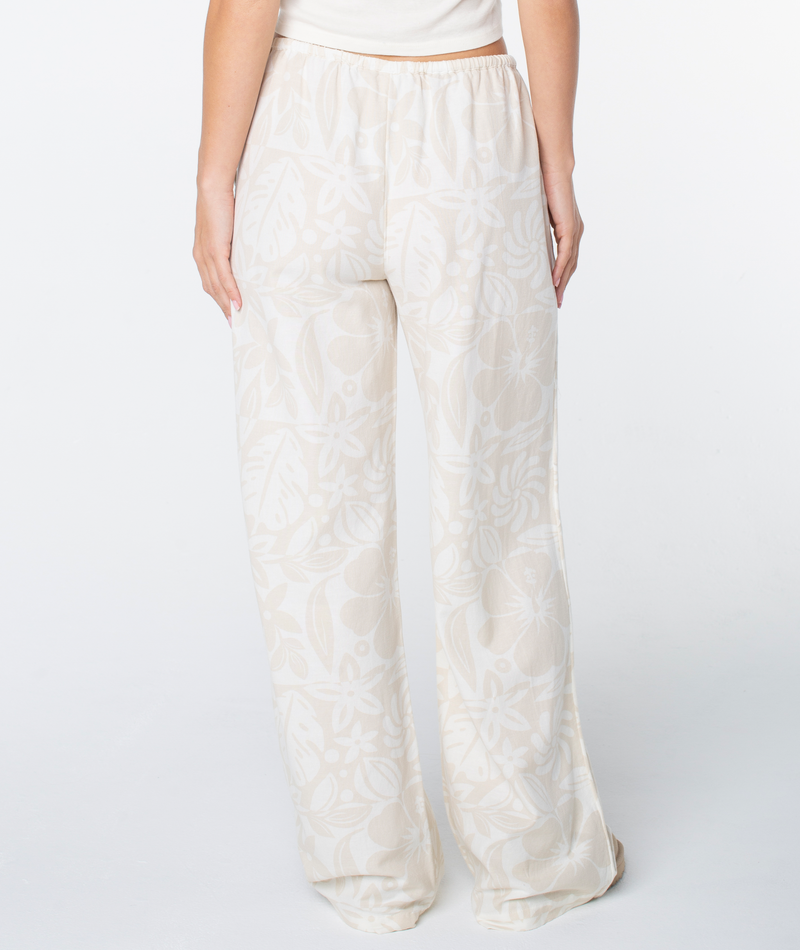 Rear view of Roxy Iyla Pant 2 cream and beige floral print coastal pants with a high-waisted, relaxed fit.