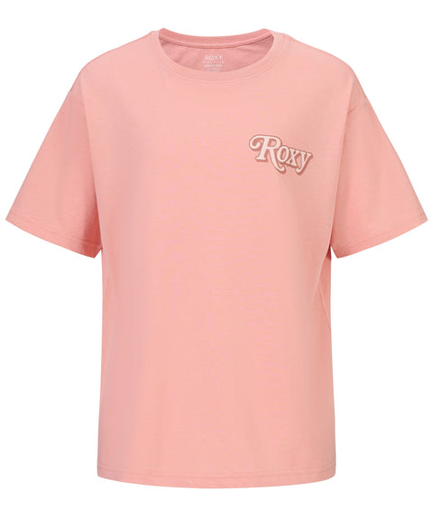 The Girls' Wavy Daze Oversized Tee by Roxy is a light pink short-sleeve crewneck featuring white, cursive "Roxy" lettering on the left chest and a relaxed fit—perfect for laid-back coastal style.