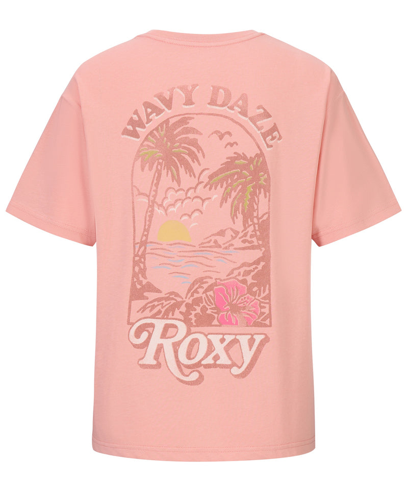 The Girls' Wavy Daze Oversized Tee by Roxy features a light pink color and back graphic with palm trees, waves, sunset, and hibiscus flower. "WAVY DAZE" and "Roxy" text complete this fun coastal-inspired tee.