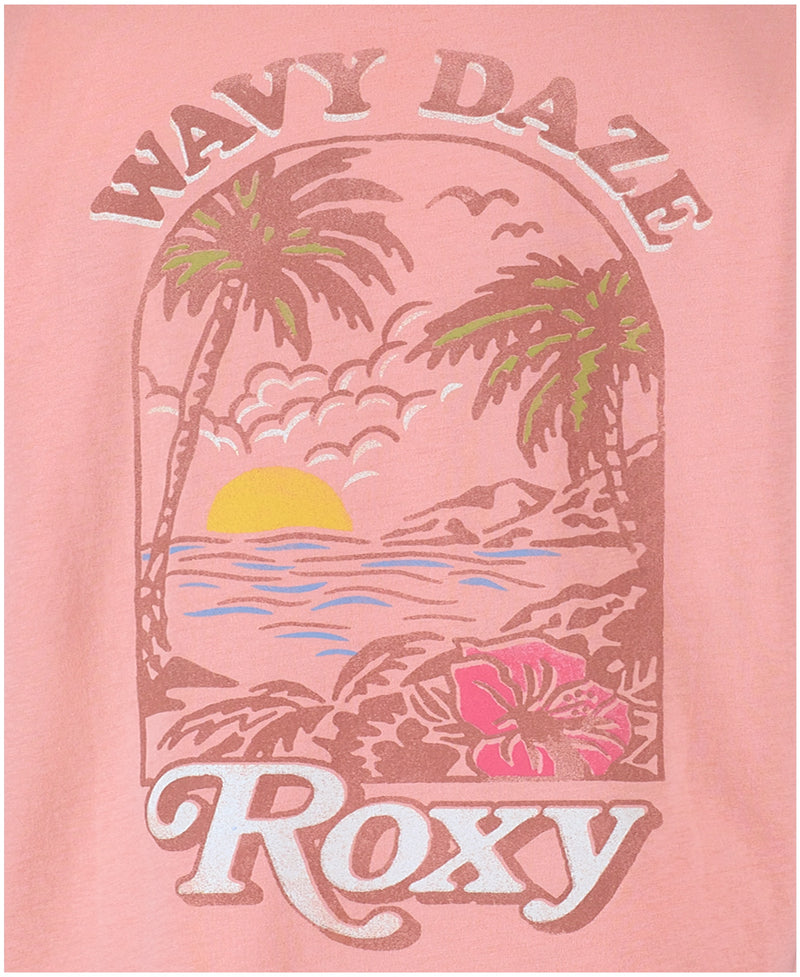 The Roxy Girls' Wavy Daze Oversized Tee features a pink beach graphic with palm trees, an ocean sunset, clouds, a hibiscus flower, and “WAVY DAZE” at the top—perfect for coastal vibes.