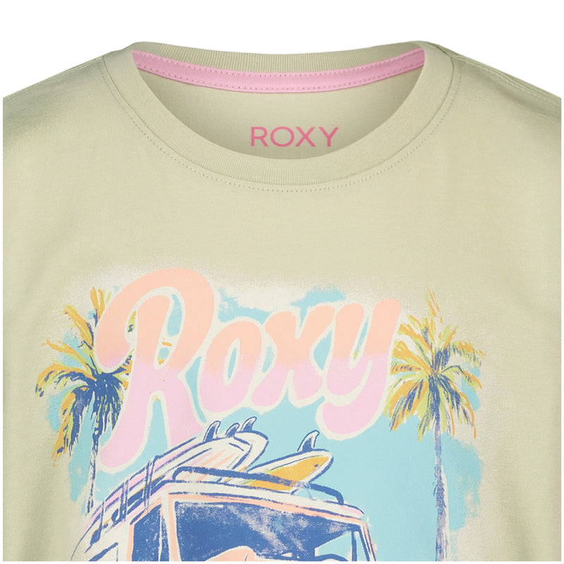 A close-up of the Roxy Girls' Coastal Oversized Tee in pale green, made from soft cotton jersey. Large pastel ROXY letters feature palm trees and a surf vehicle for a tropical, beach-inspired look.