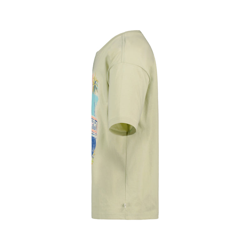 Side view of the Girls' Coastal Oversized Tee by Roxy in light beige cotton jersey, featuring a vibrant ROXY graphic on the front, shown against a plain white background.