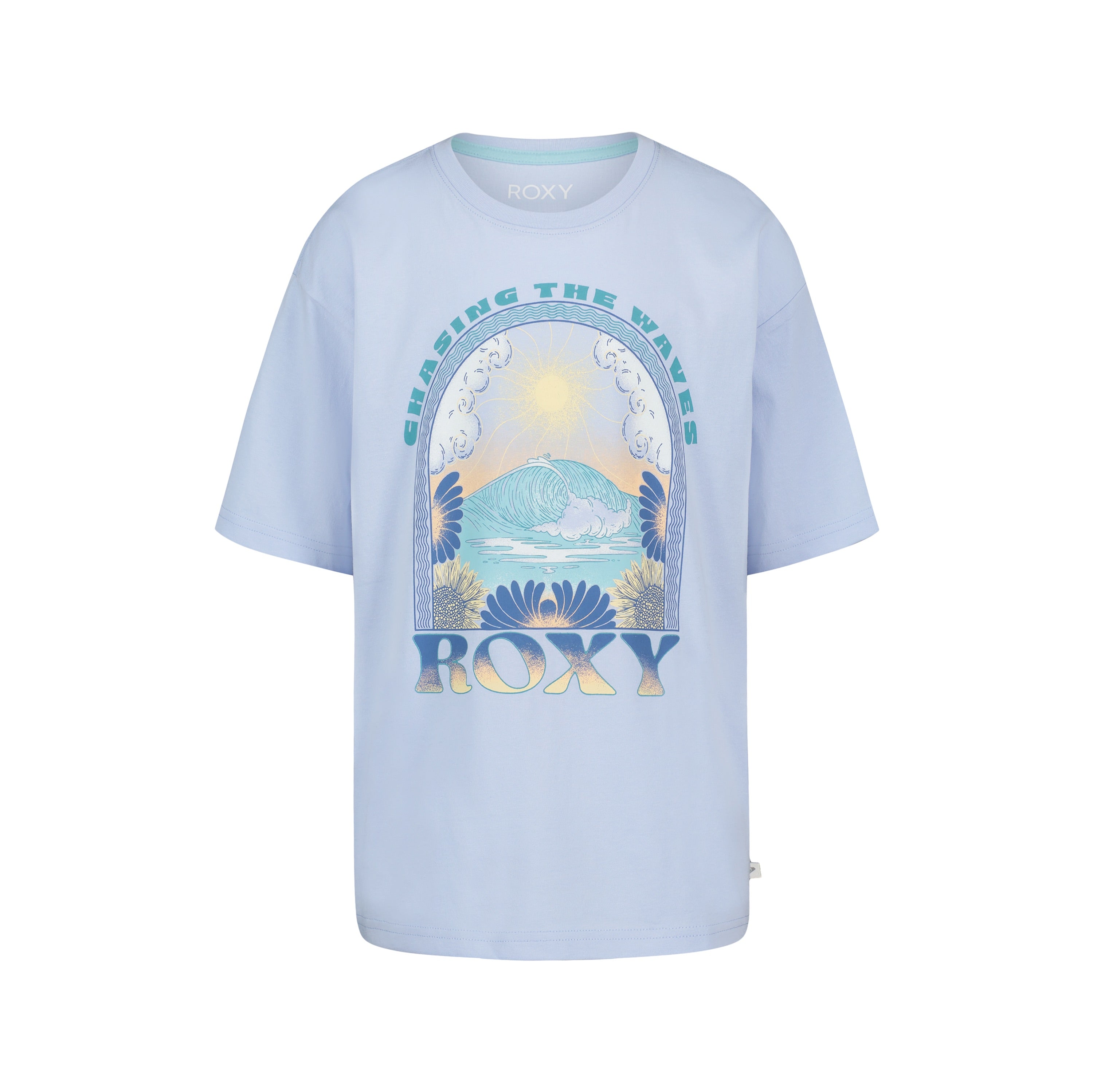 The Roxy Girls' Chasing Waves Oversized Tee is made from soft cotton jersey and features a light blue color, ocean wave, sun, and flower graphics, with "CHASING THE WAVES" above and "ROXY" below the illustration.