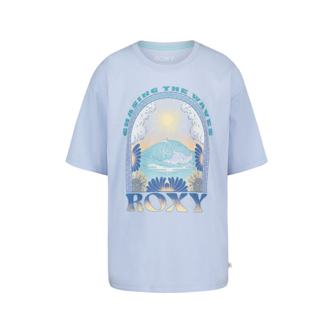 The Roxy Girls' Chasing Waves Oversized Tee is made from soft cotton jersey and features a light blue color, ocean wave, sun, and flower graphics, with "CHASING THE WAVES" above and "ROXY" below the illustration.