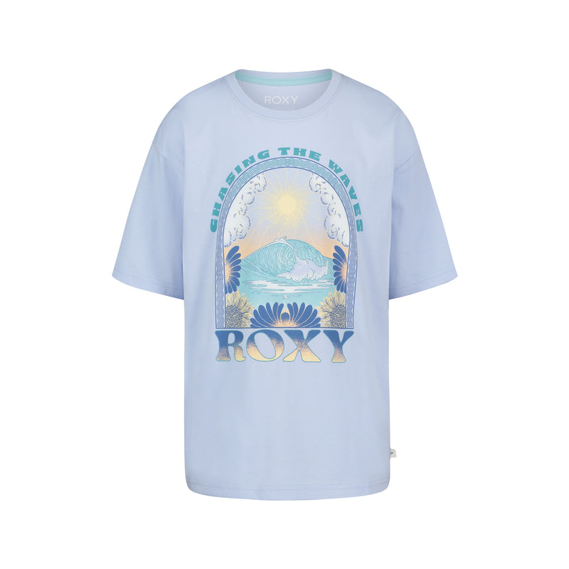 The Roxy Girls' Chasing Waves Oversized Tee is made from soft cotton jersey and features a light blue color, ocean wave, sun, and flower graphics, with "CHASING THE WAVES" above and "ROXY" below the illustration.