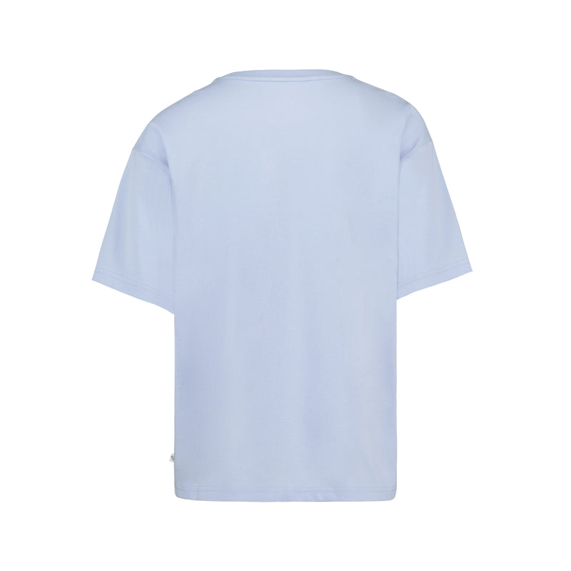 The Girls' Chasing Waves Oversized Tee by Roxy is shown from the back in plain light blue, made of soft cotton jersey with no visible logos, patterns, or designs.