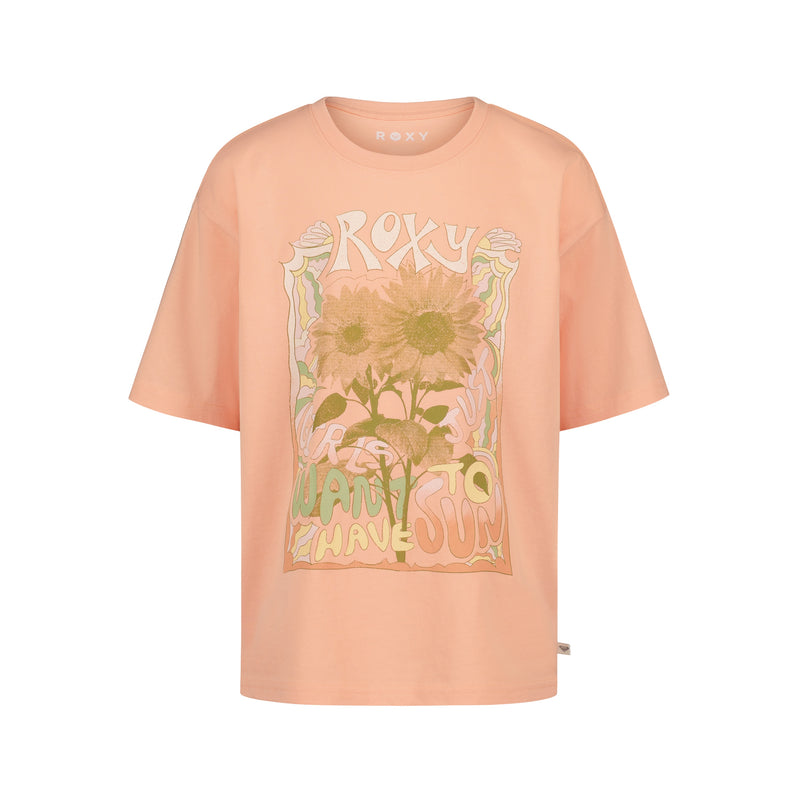 The Girls' Sunshine Oversized Tee by Roxy is a peach-colored cotton jersey shirt with two sunflowers and wavy "ROXY" and "Want to Have Sun" graphics on the front, featuring a relaxed, short-sleeve fit.