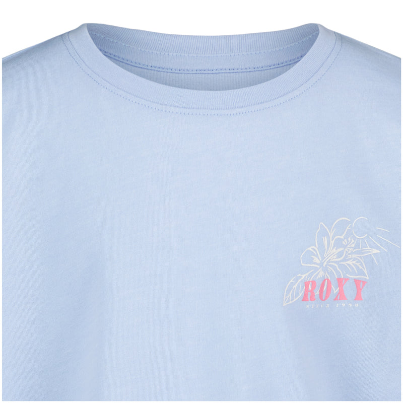 The Girls' Coastal Journey Long Sleeve Tee by Roxy features a light blue color, small white floral graphic, and pink lettering on the upper left chest—perfect for adding coastal style to any outfit.