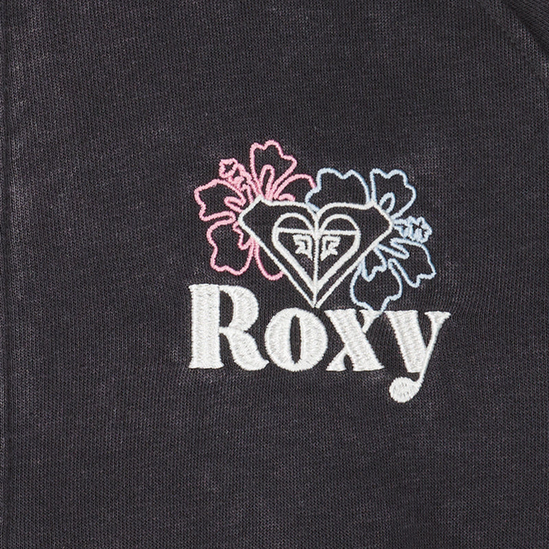 Close-up of the Roxy Girls' Heartbeat Half-Zip Hoodie in black cotton-poly fleece with "Roxy" embroidered in white, a heart-shaped logo, and two hibiscus flowers outlined in pink and blue.