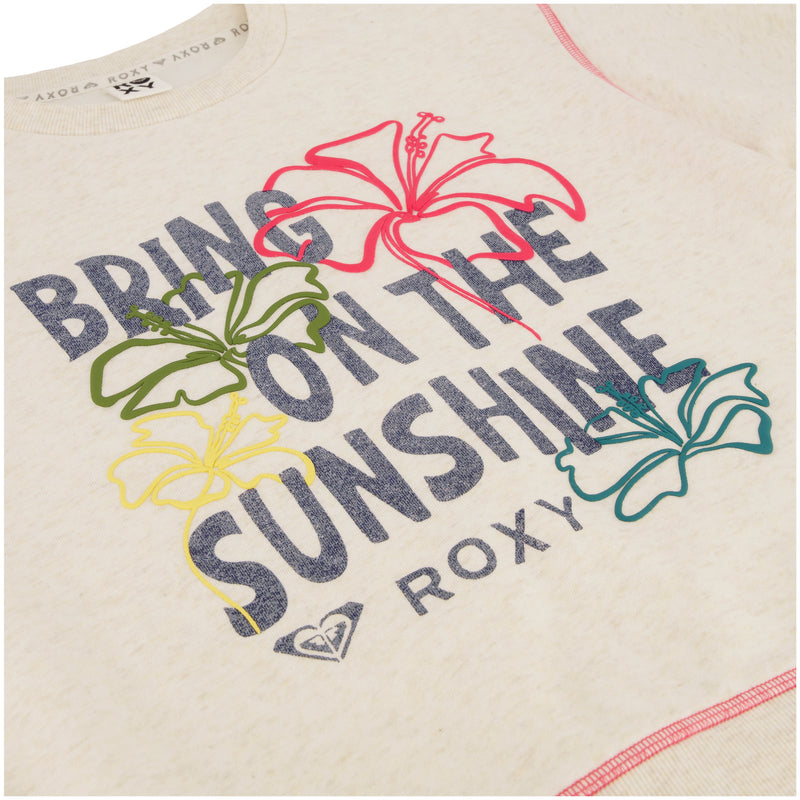 Close-up of the Roxy Girls' Sunshine Crew, an oversized light-colored pullover with bold "BRING ON THE SUNSHINE" text and colorful hibiscus flower prints—ideal for the beach.