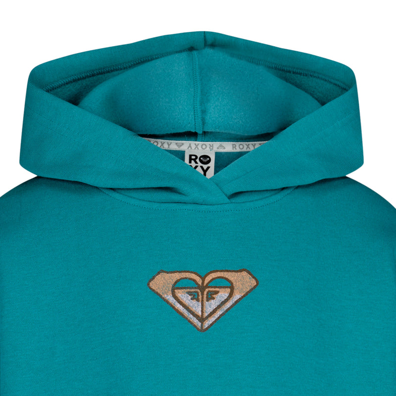 Close-up of the teal Girls' Wildflower Hoodie by Roxy, featuring a hood and a stitched brown and white Roxy logo on the chest. The inner neckline tag with the Roxy brand name is visible, making it a cozy beach option.
