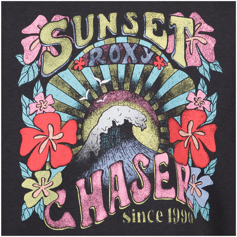 The Girls' Sunny Crew by Roxy features a colorful "Sunset Chaser since 1990" graphic with waves, sun rays, and hibiscus flowers on a black cotton-poly fleece pullover in an oversized fit.