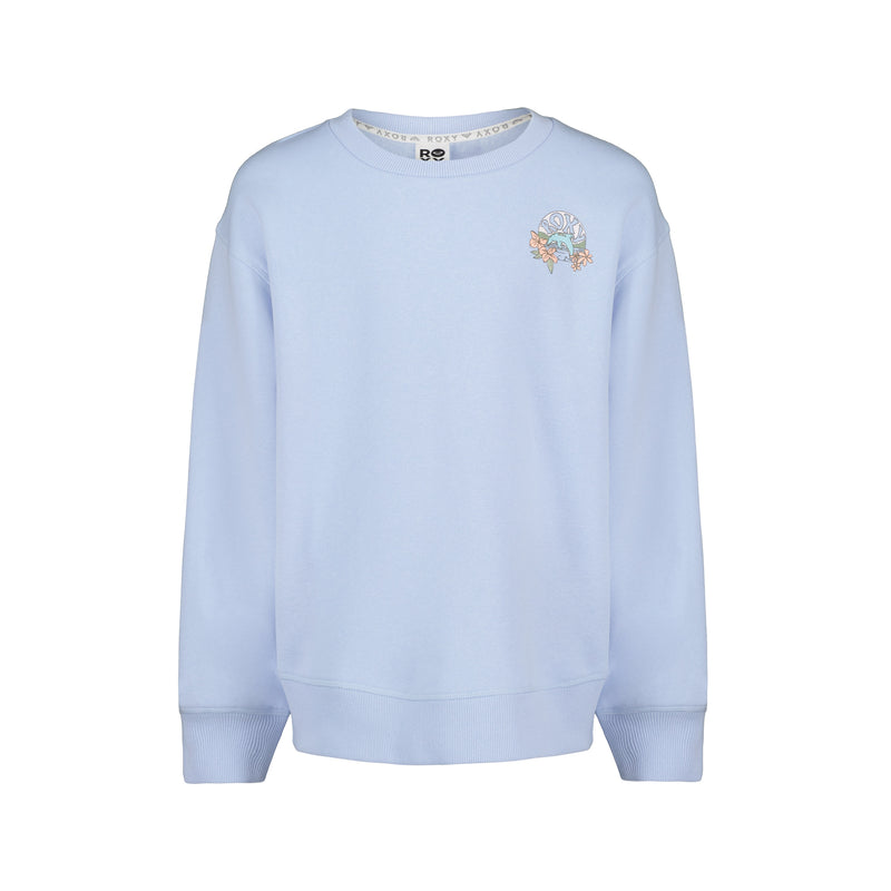 The Roxy Girls’ Ocean Explorer Crew is a light blue pullover sweatshirt featuring a crew neck, ribbed cuffs and hem, and a small, colorful floral graphic with text on the upper left chest. Shown against a plain white background.