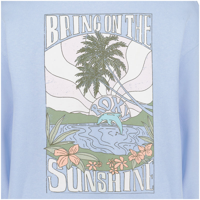 A scenic beach graphic with palm trees, a sunrise, flowers, water, and mountains decorates the Girls’ Ocean Explorer Crew from Roxy. The words “BRING ON THE SUNSHINE” appear above the scene, while “Roxy” with a wave is featured in the water. Soft pastel tones bring color to this crewneck pullover sweater.