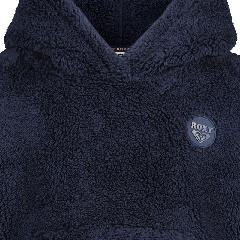 Close-up of a navy blue, plush Roxy Girls’ Minky Hoodie with a circular logo patch on the chest.