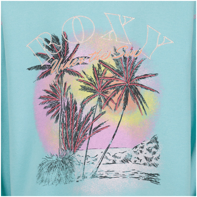 Light blue Roxy Girls’ Have A Swell Day Crew sweatshirt featuring palm trees on a beach in front of a colorful sun, with Under the Sun printed below the brand name.
