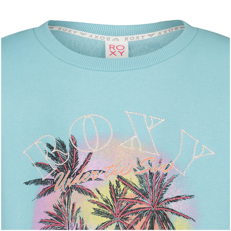 Light blue oversized Girls’ Have A Swell Day Crew featuring a graphic of palm trees, a sunset, and the text Under the Sun with an outline of the Roxy brand name.