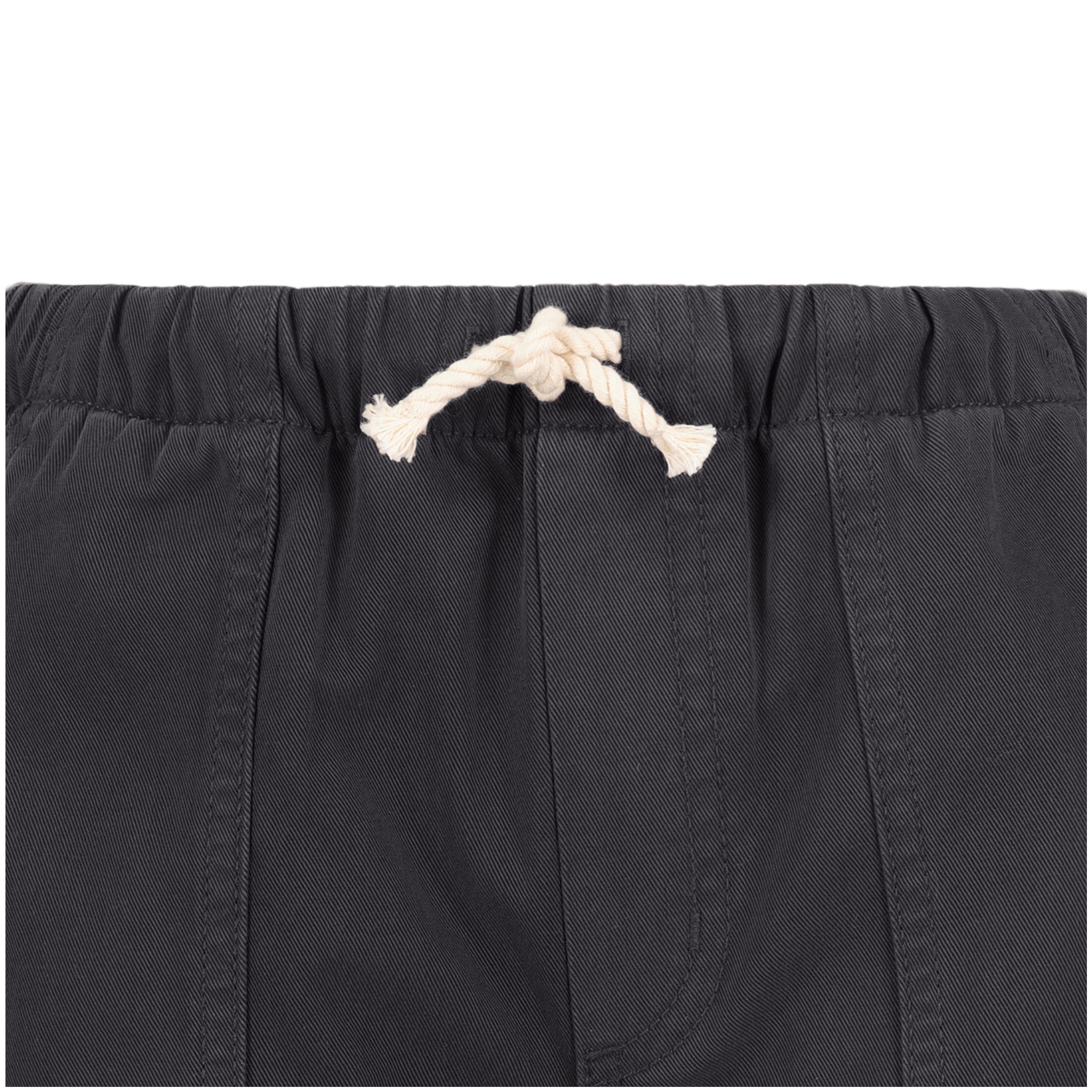 Close-up of the waistband on Roxy's Girls' Precious Cargo Pant in dark gray, featuring an off-white drawstring knot, visible stitching, and gathered elastic. Made from durable cotton canvas twill.