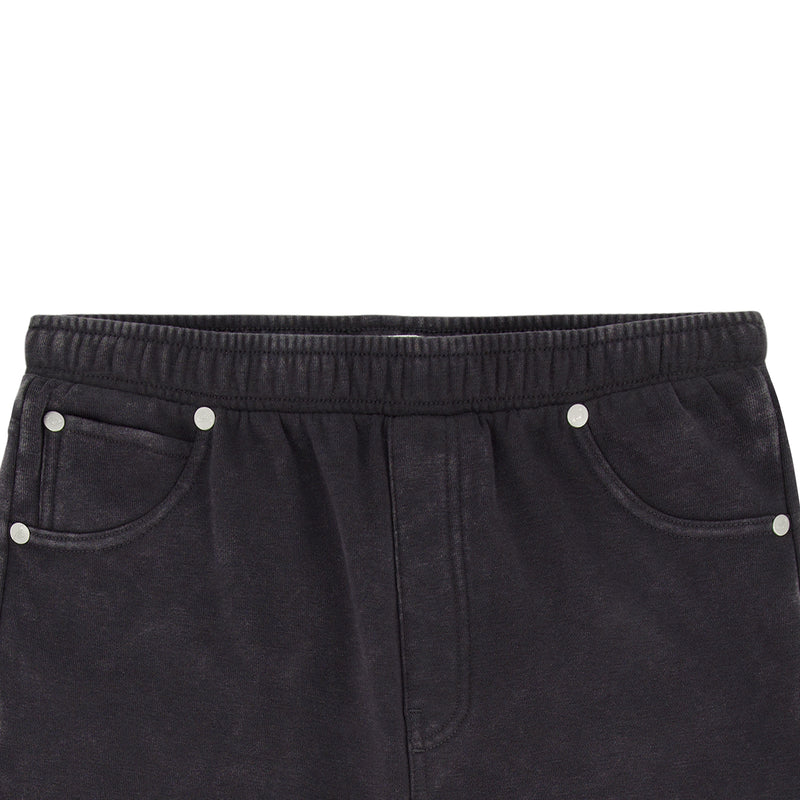 Close-up of the waistband and top section of the Roxy Girls' Jump Start Jogger, featuring black cotton fleece, an elastic waist, and silver rivets on the front pocket edges.