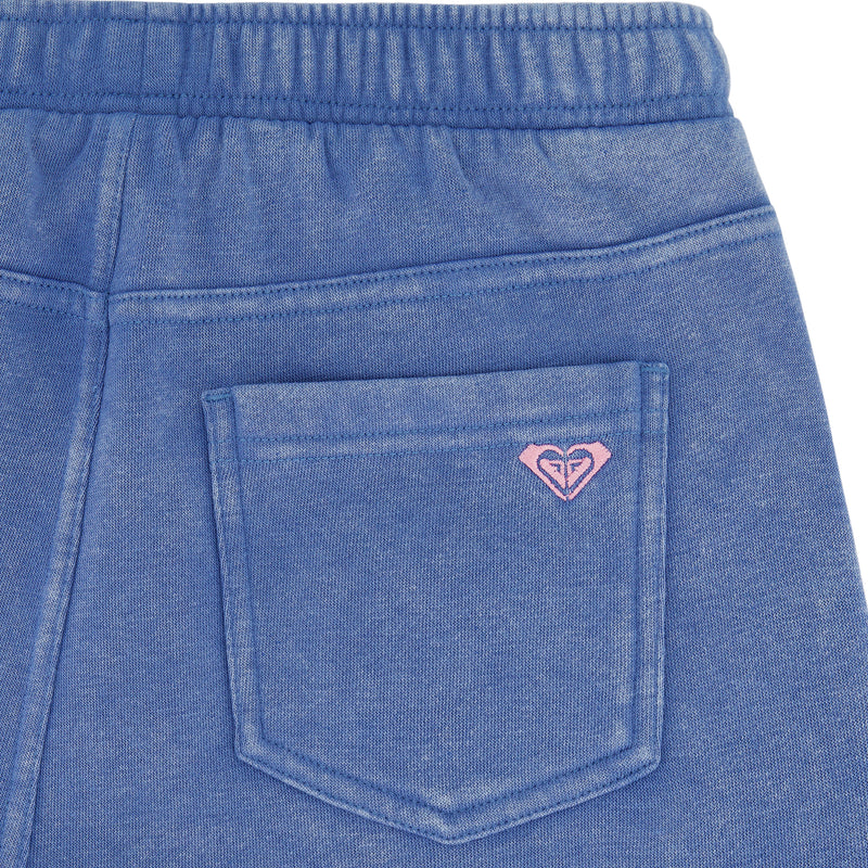 Close-up of the back pocket on Roxy Girls' Jump Start Jogger shorts, featuring an elastic waistband for comfort and a small pink embroidered heart-shaped logo above the pocket.