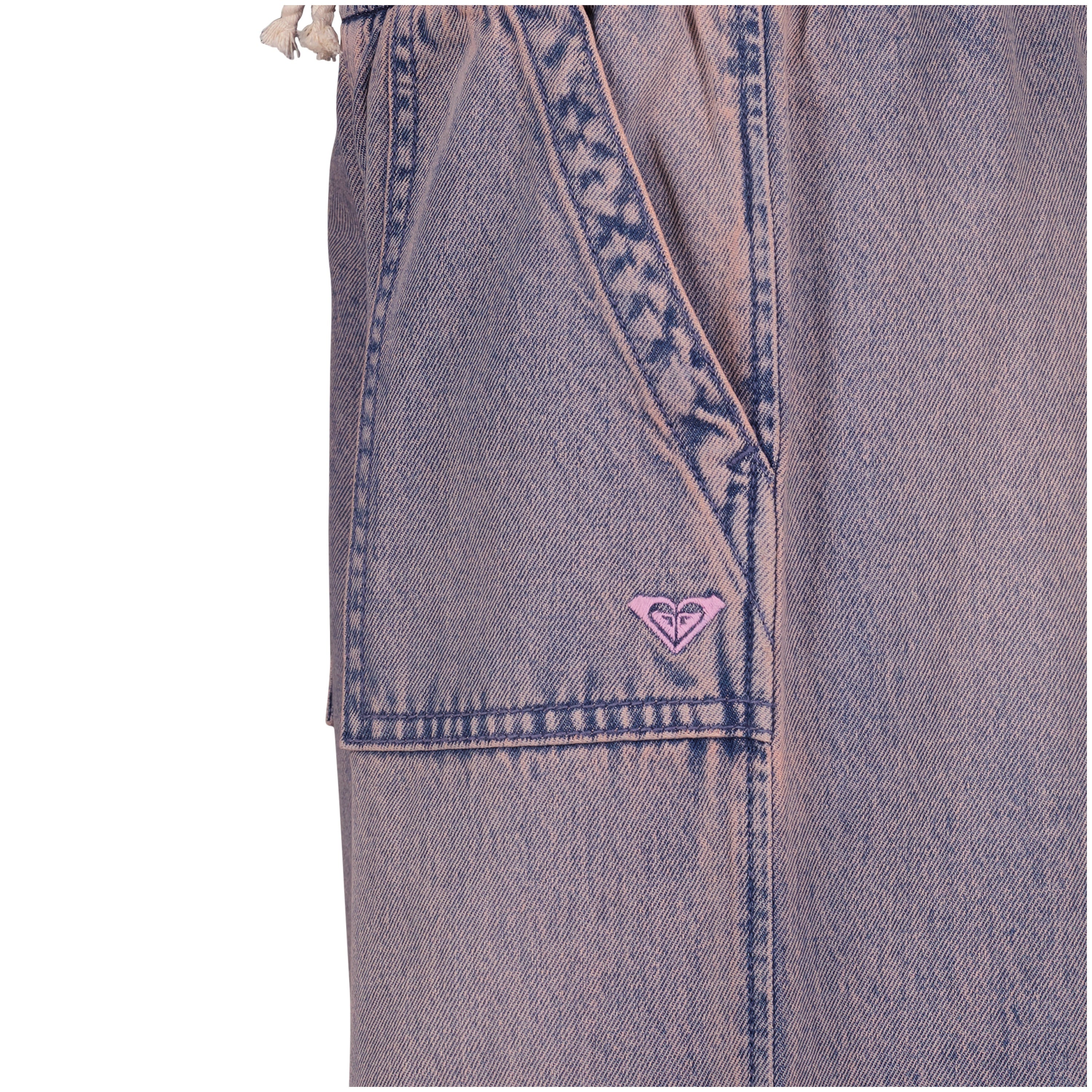 Close-up of the Roxy Girls' Denim Himalayan Pant in light purple-pink cotton denim, featuring a front pocket, stitched details, and a small pink embroidered logo by the seam.
